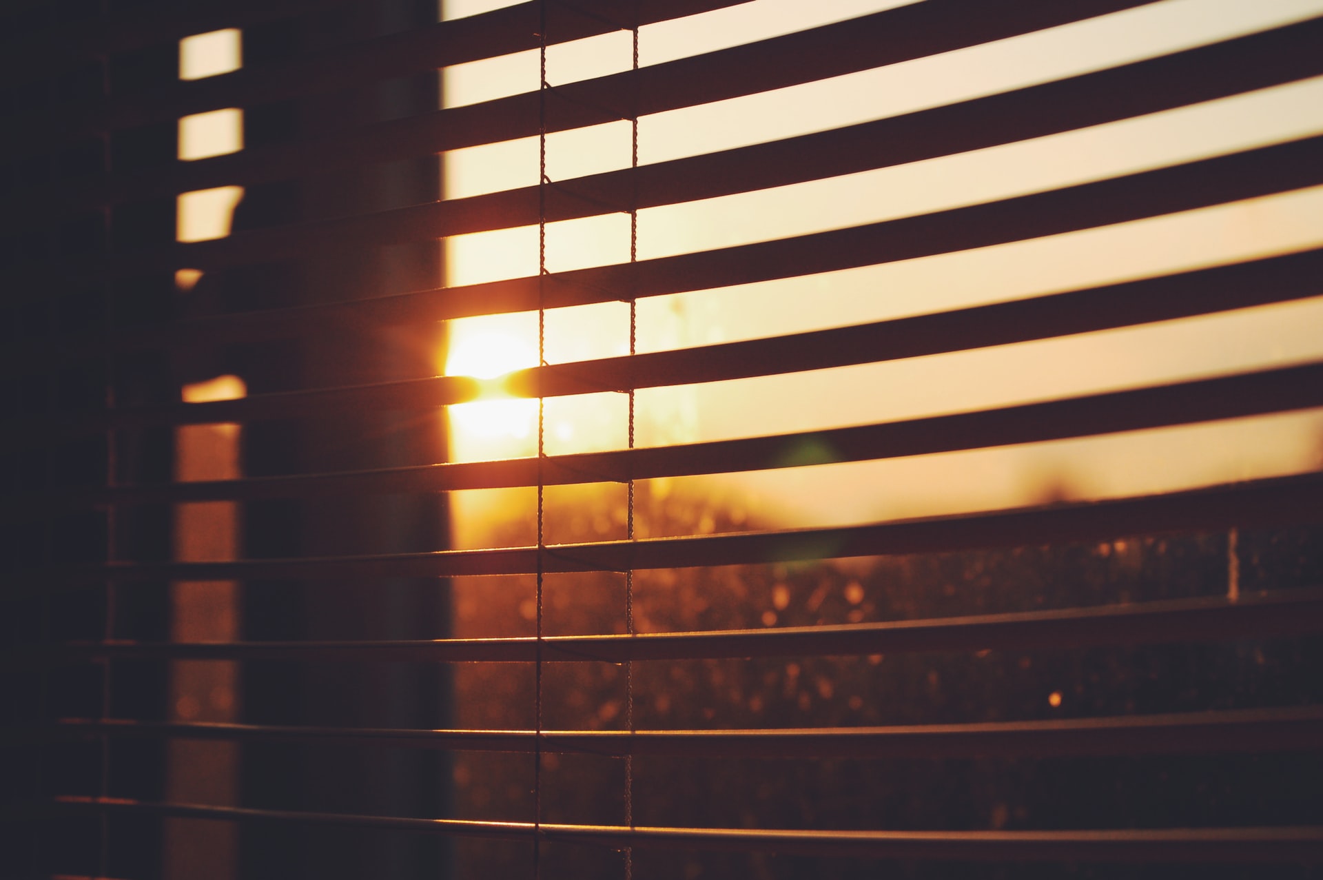 Window blinds open during sunset